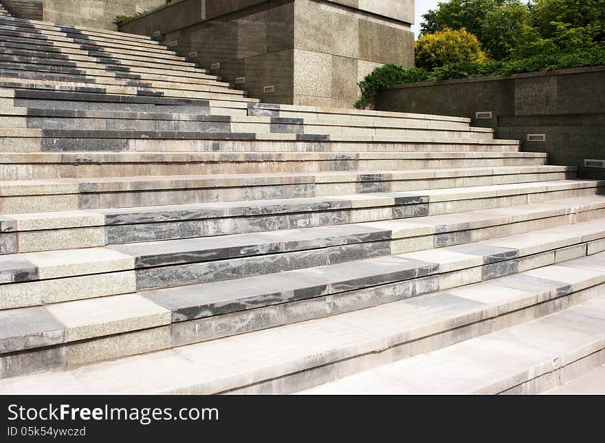 High granite staircase withgreen trees on summer day