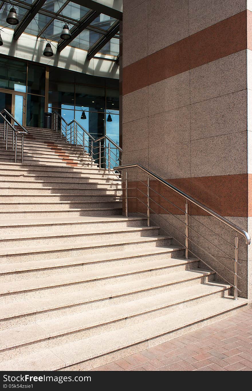 Outdoor granite staircase with metal railing of city house