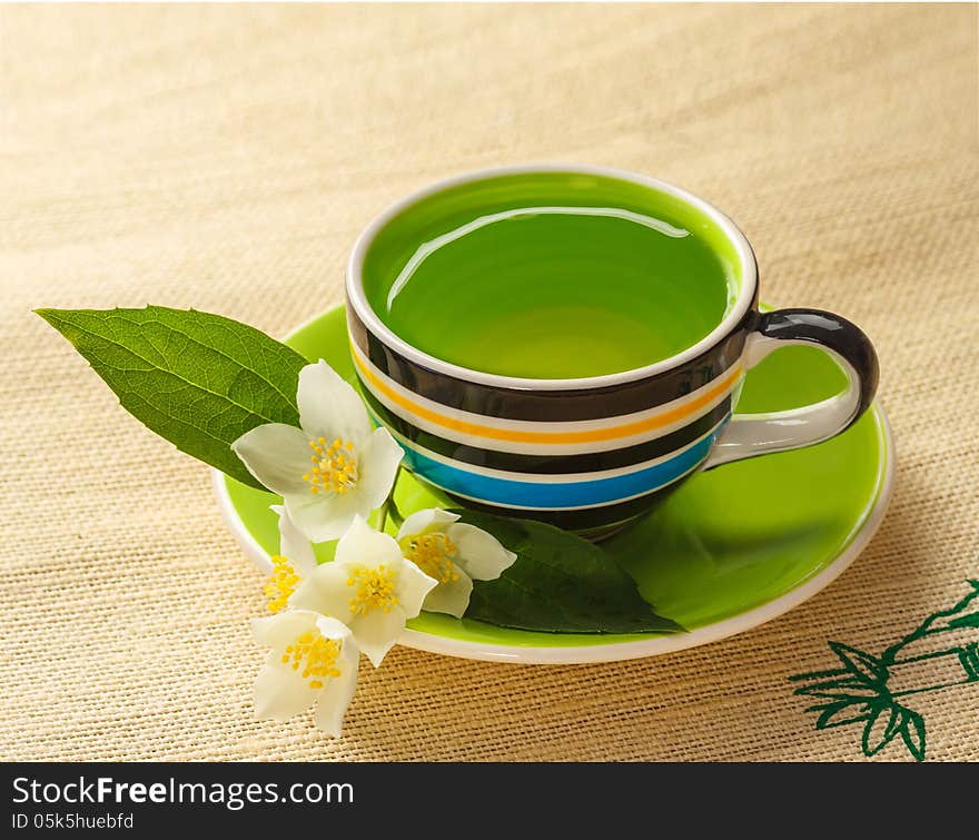 Cup of jasmine tea and jasmine flowers