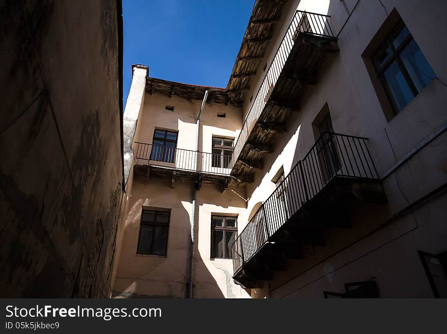 Illuminated by sun wall of the old house, the view from the courtyard. Lviv, Ukraine