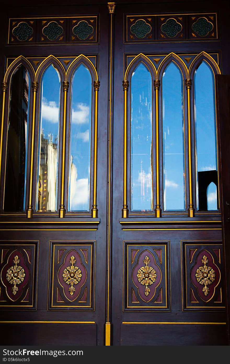 Detail of stained glass reflection in the doors of a Catholic Church. Detail of stained glass reflection in the doors of a Catholic Church