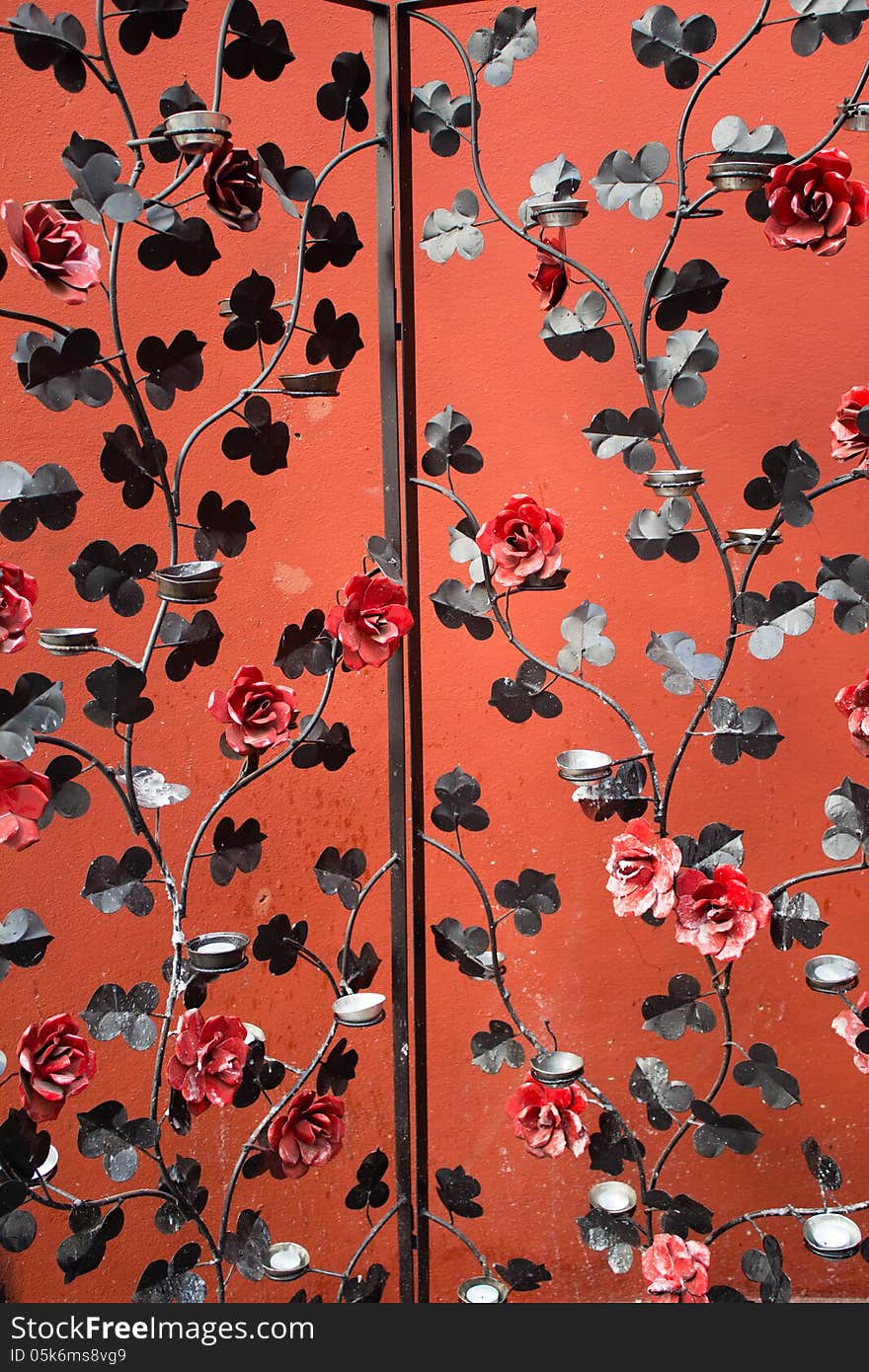 Iron Screen Partition with red flowers and candles holders.