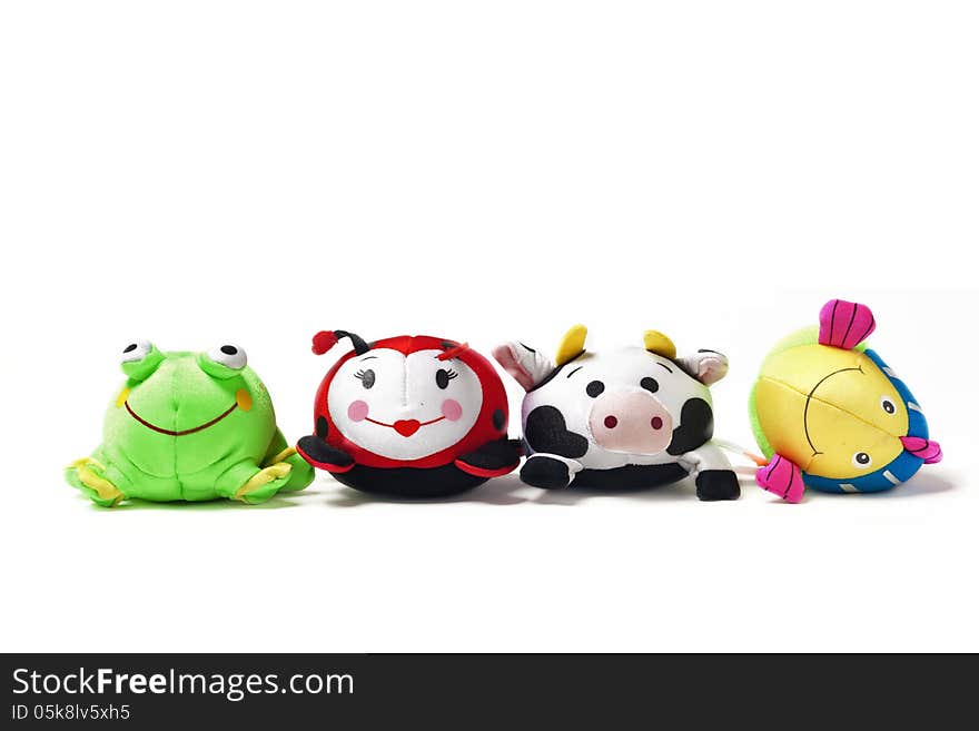 Toy frog, ladybug, cow and fish sit in a row. Toy frog, ladybug, cow and fish sit in a row.