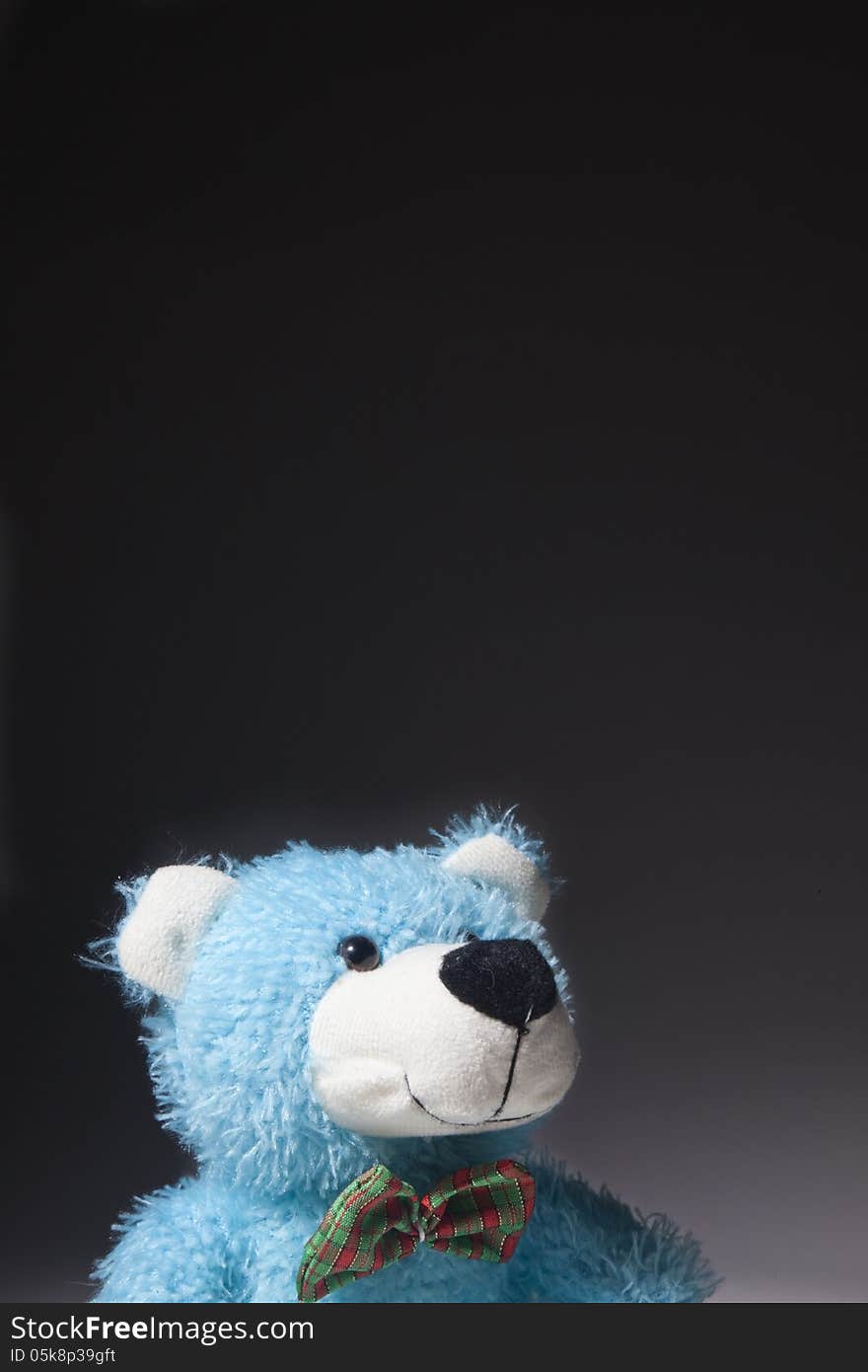 A blue bear stares up in a thoughtful happy way. A blue bear stares up in a thoughtful happy way.