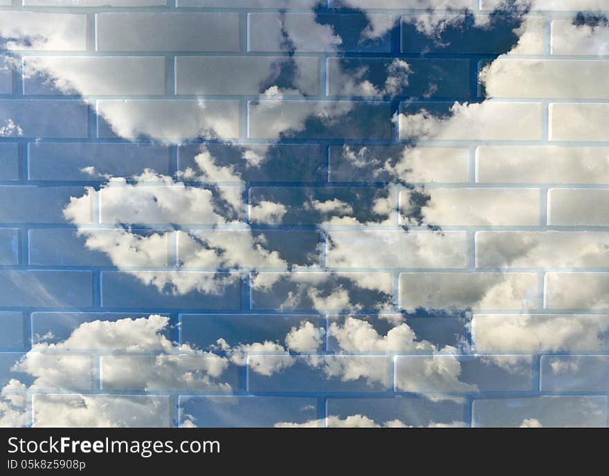 A cloudy blue sky in a brick wall.