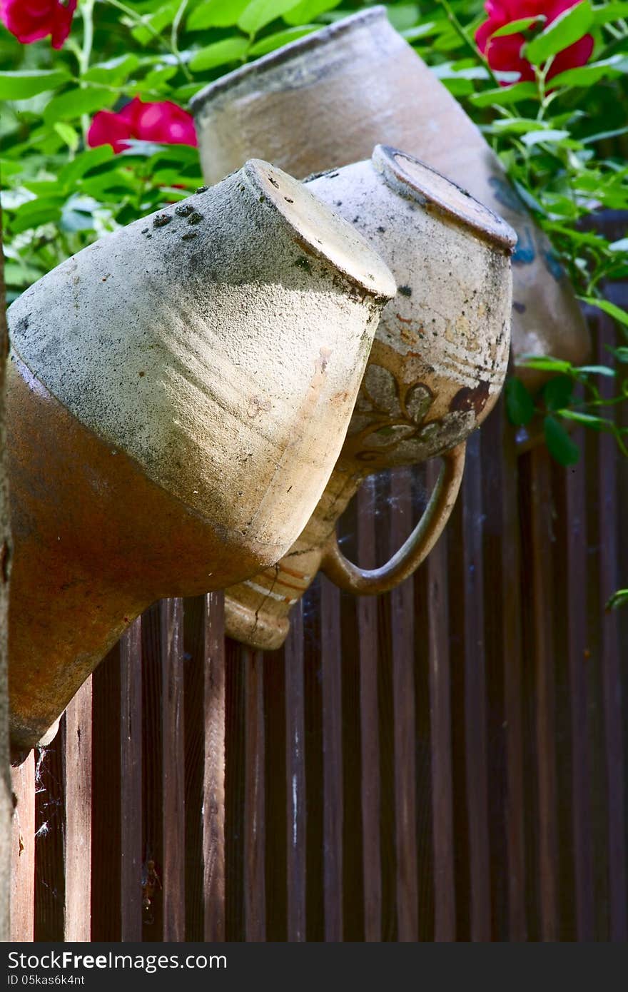 Old jugs on a rustic fence