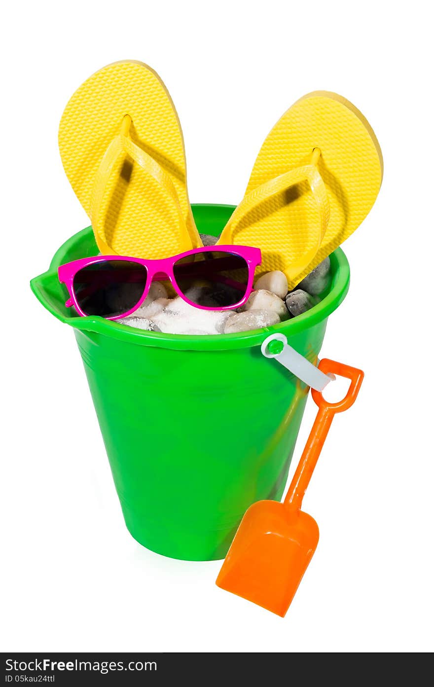 Vertical shot of a sand pail with sand, rocks, flip flops and sunglasses. Isolated on a white background. Vertical shot of a sand pail with sand, rocks, flip flops and sunglasses. Isolated on a white background.