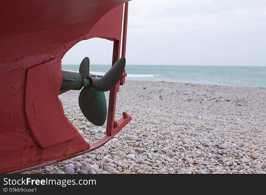 Keel and propeller of boat on the background of the sea shore