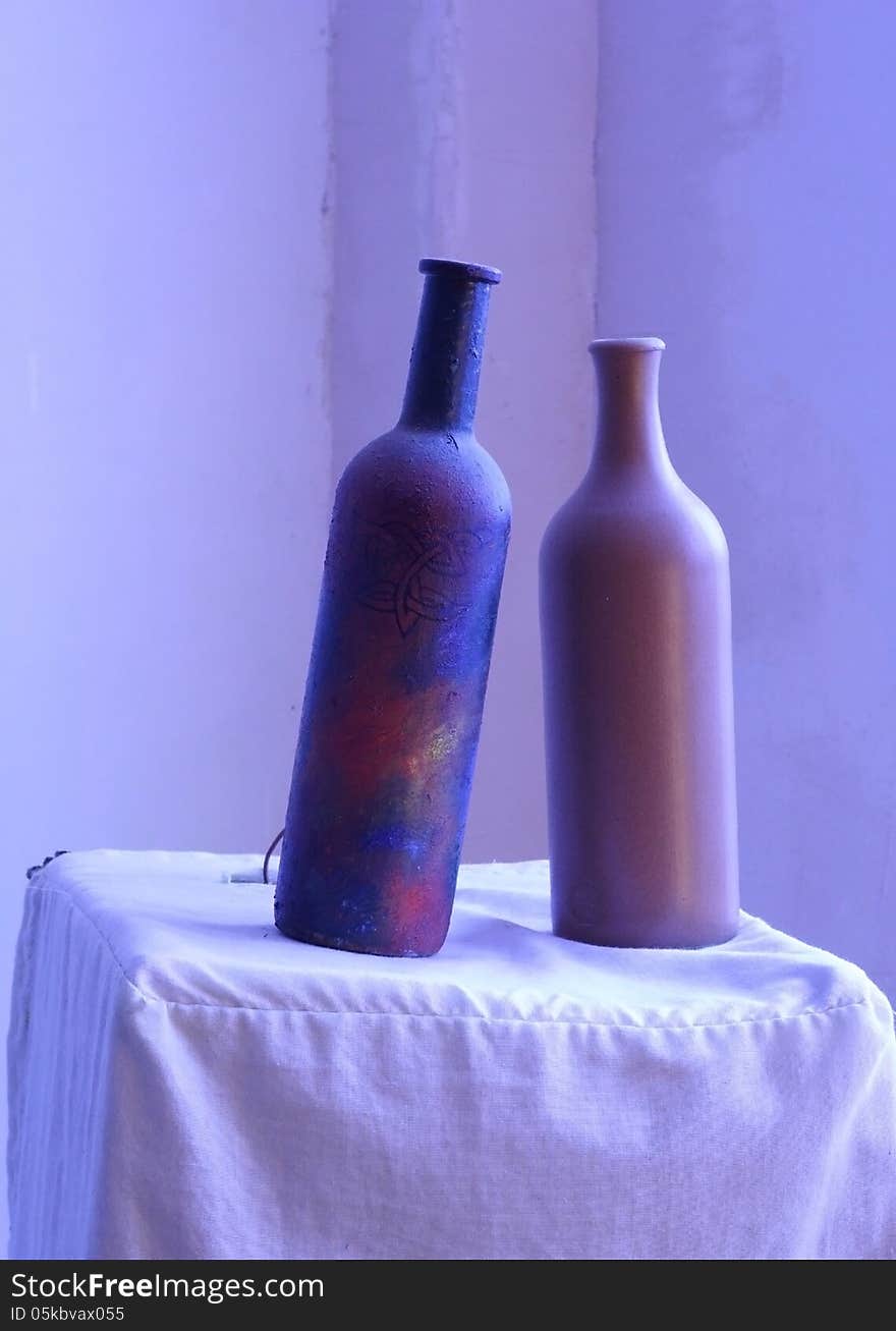 Two clay bottle peacefully standing on the table