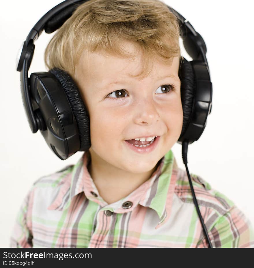 Portrait of little cute boy in earphones isolated