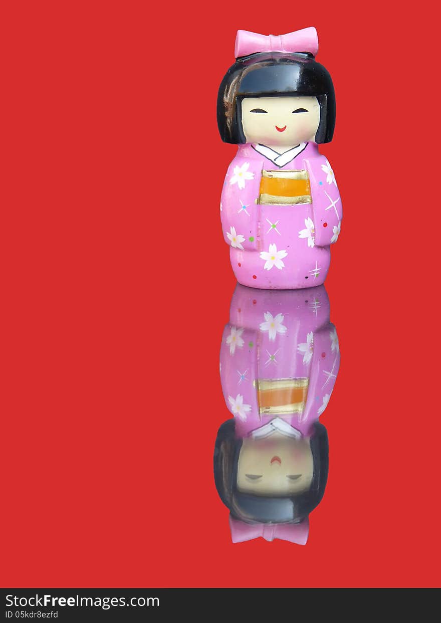 Porcelain chinese figurine with mirror image on a red background, front view. Porcelain chinese figurine with mirror image on a red background, front view