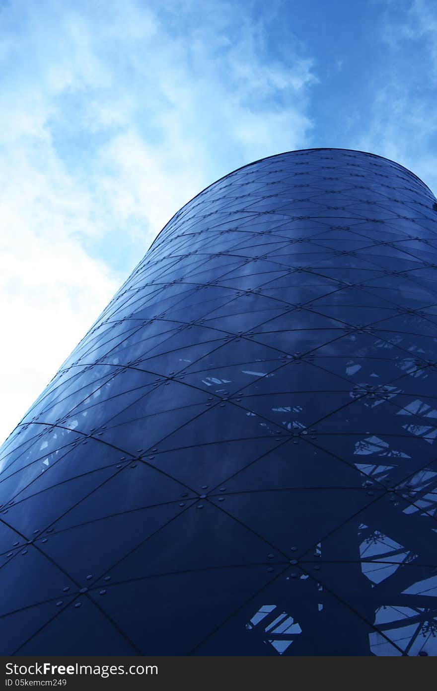 Rounded office building with cloudy sky