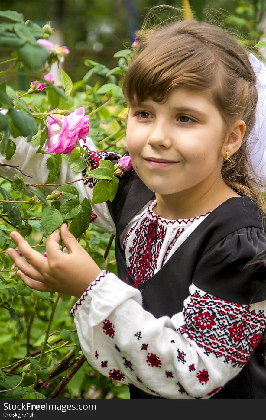 Girl in a bush of roses. This image has attached release.