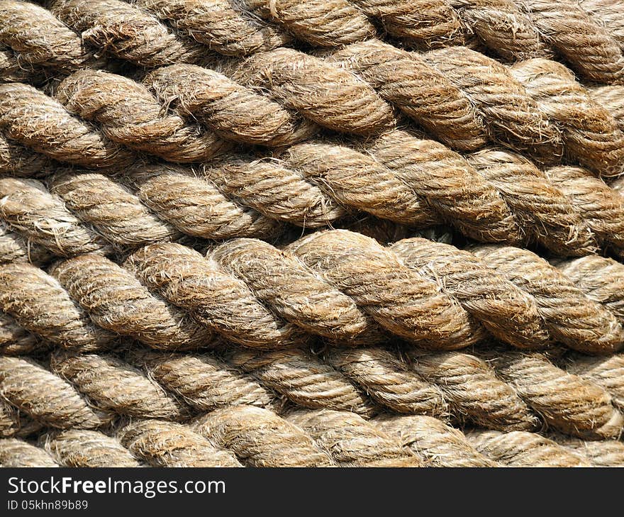 Stacked spool of rope in a horizontal pattern illuminated by sunlight