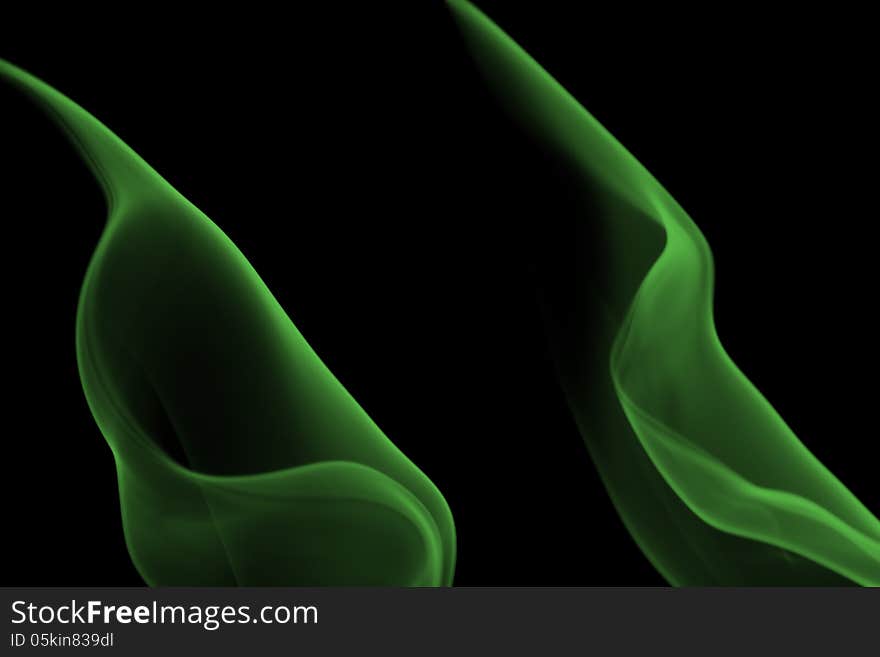 Abstract green cigarette smoke shape on black