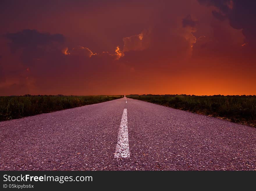 Driving on an empty road at sunset