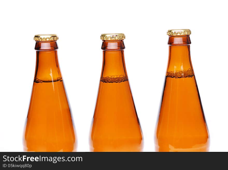 Three brown neck bottles on a white background