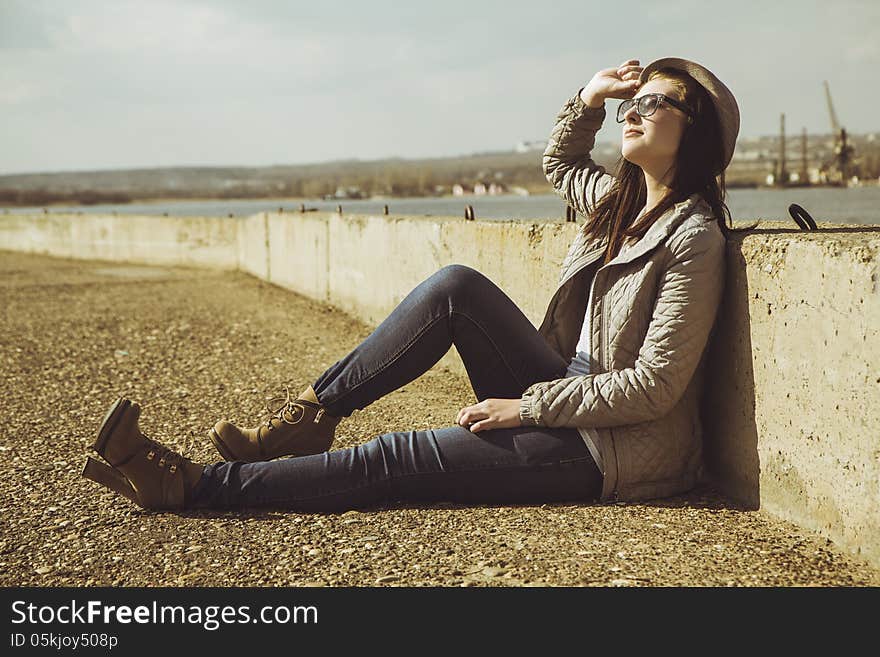 Pretty young teenager sitting on sidewalk. Pretty young teenager sitting on sidewalk