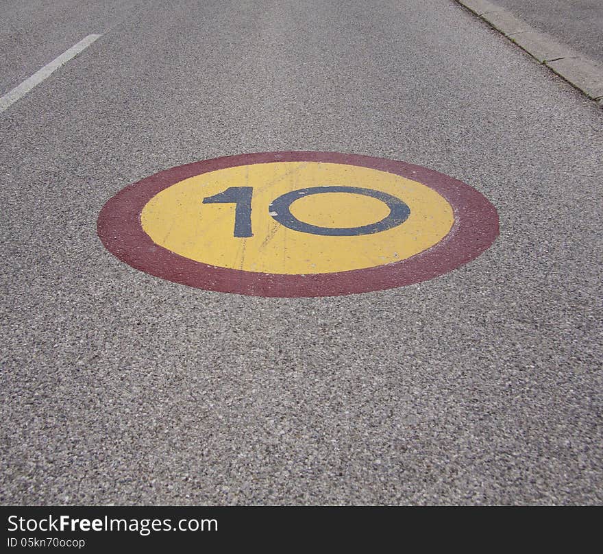 Speed limit sign painted on asphalt