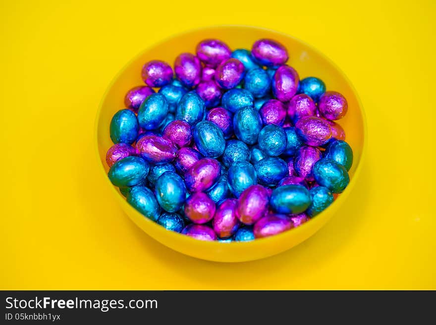 Colorful candy closeup on yellow background