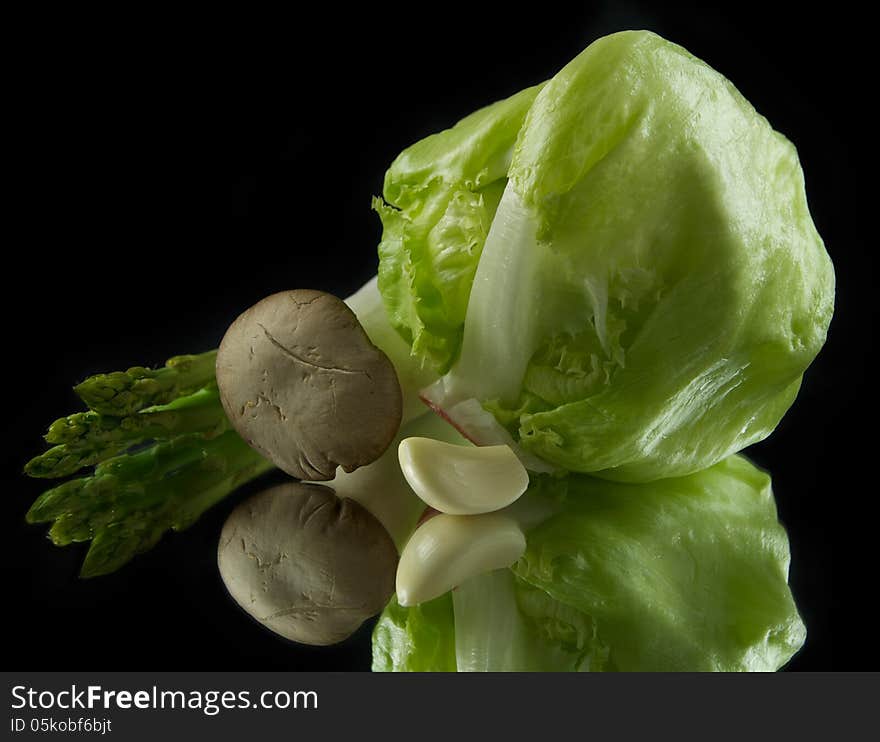 Сabbage, mushrooms, garlic and asparagus isolated on black