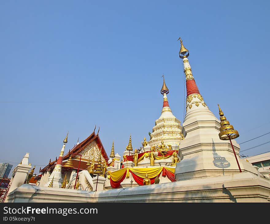 Chapel and white pagoda with gold decoration at wat songtham, Phra Pradaeng, Samut Prakan province, Thailand. Chapel and white pagoda with gold decoration at wat songtham, Phra Pradaeng, Samut Prakan province, Thailand