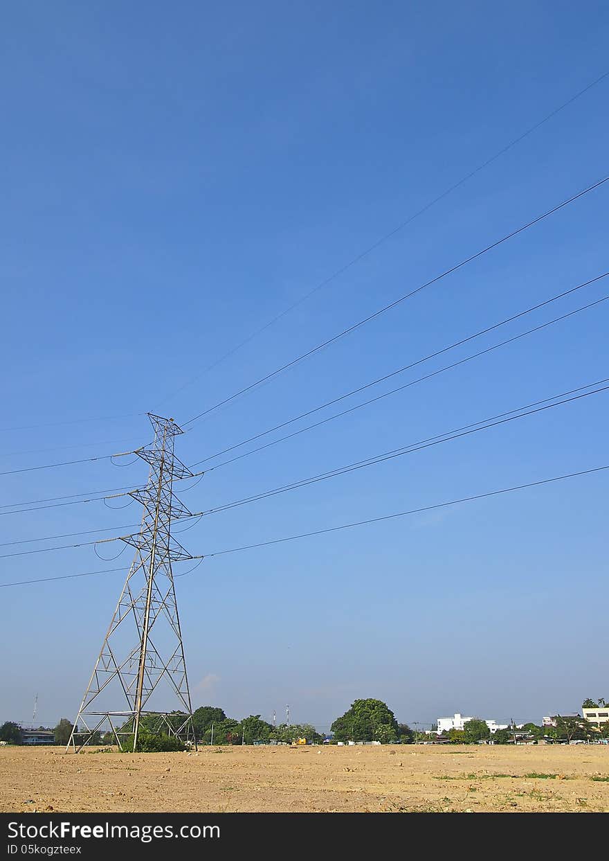 High voltage tower and cable line cross is terrain in blue sky. High voltage tower and cable line cross is terrain in blue sky