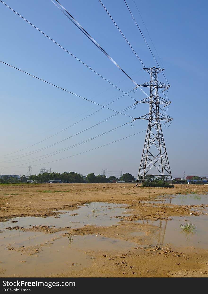 High voltage tower in wet land and blue sky