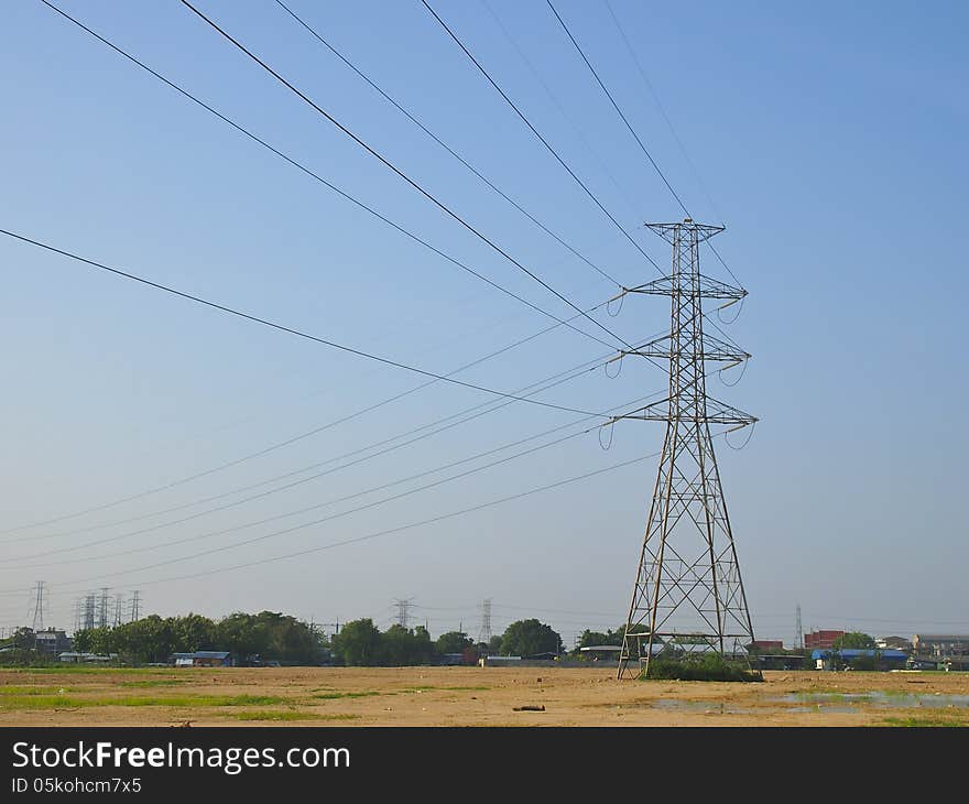 High voltage tower and grid line in plain terrain. High voltage tower and grid line in plain terrain