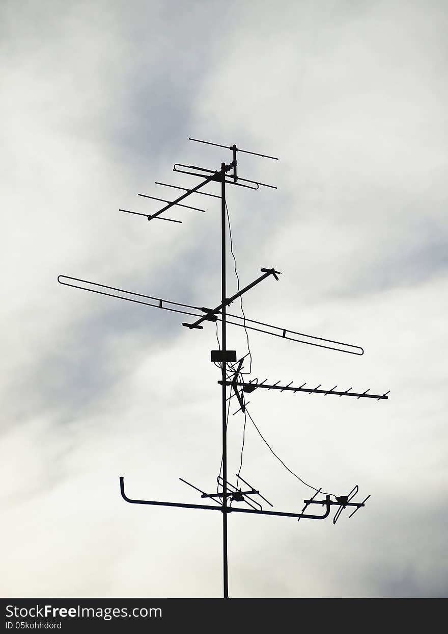 Silhouette image of antenna in cloudy sky background. Silhouette image of antenna in cloudy sky background