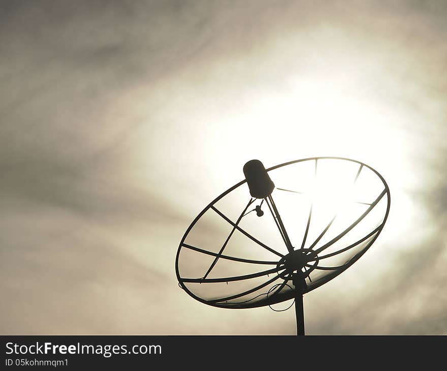 Silhouette image of satellite dish in cloudy sky. Silhouette image of satellite dish in cloudy sky