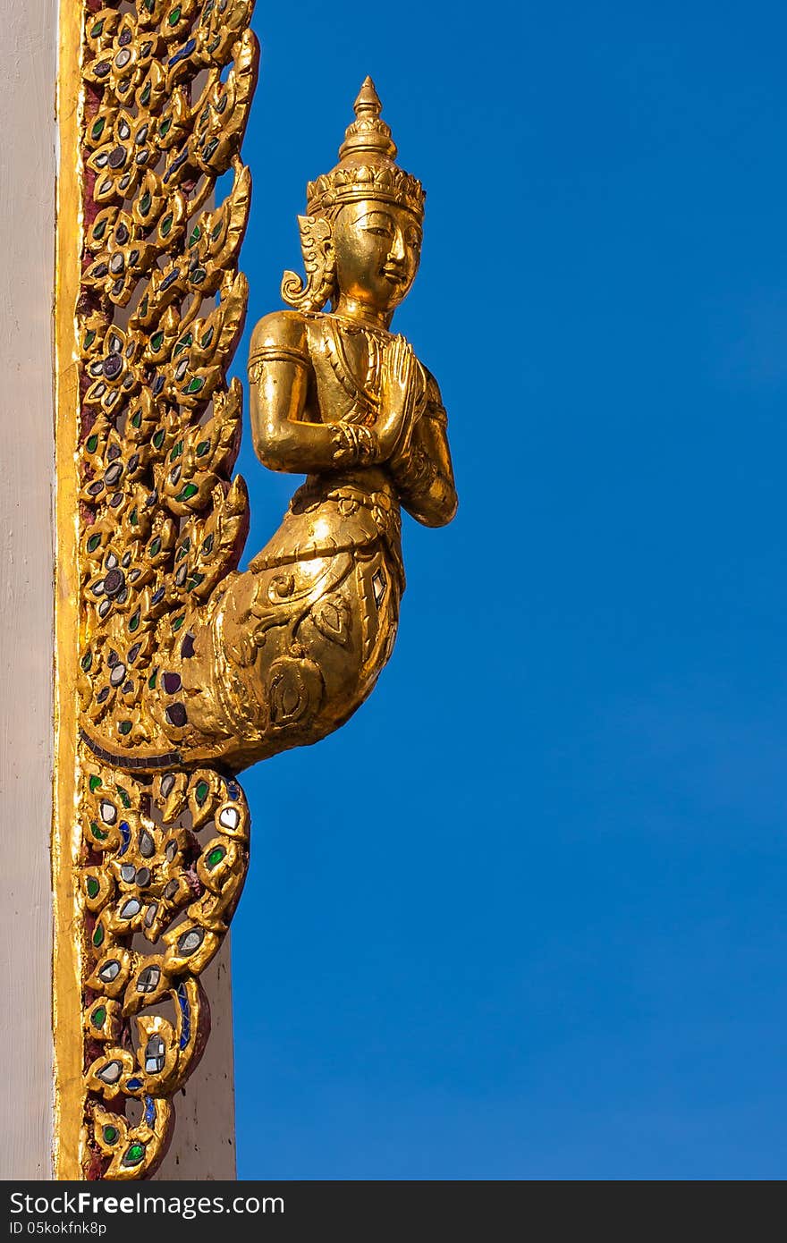 Angel sculpture at gate of buddhist church in Bangkok