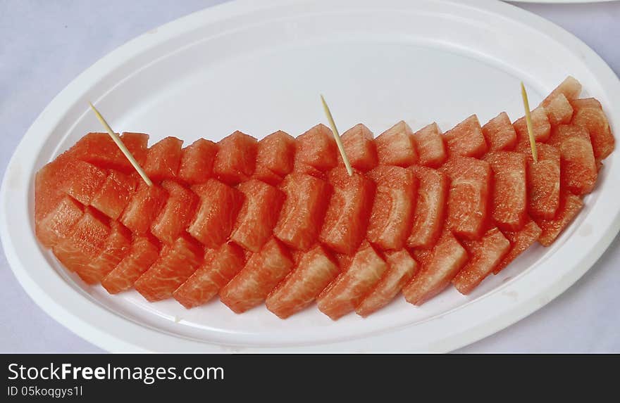 Row of sliced watermelons in dish. Row of sliced watermelons in dish.