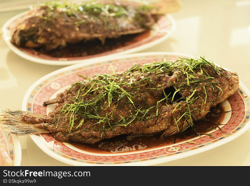 Fried fish with chili sauce In restaurant