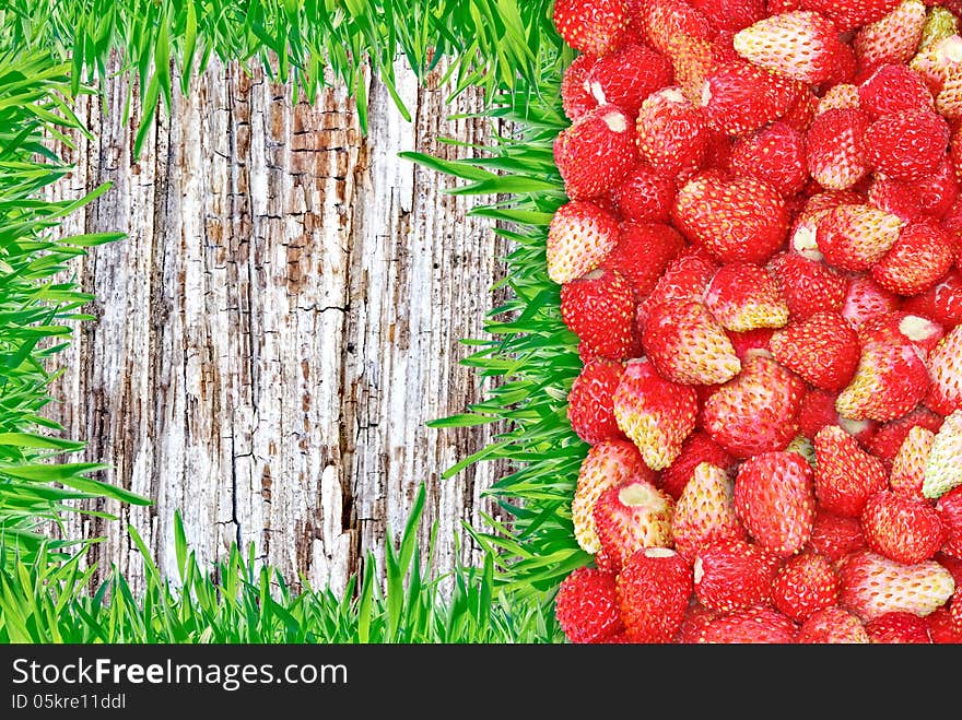 Frame Of Strawberries And Grass And Wooden Background.