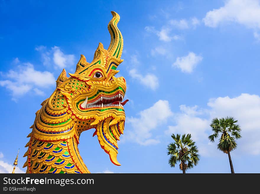 Golden Giant Snake Sculpture, North East of Thailand.(Generally in Thailand, any kind of art decoration in temples, churchs, pavilions etc. created with donated money. They are all public property or treasure, no restrict in copy or use. This photo is taken under this condition.)