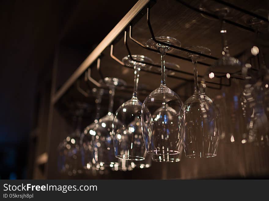 Glasses hanging over a bar rack