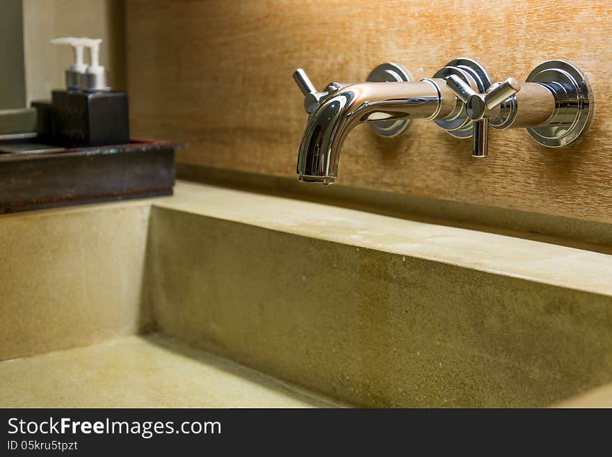 Hot cold separated shiny metal water tap in bathroom