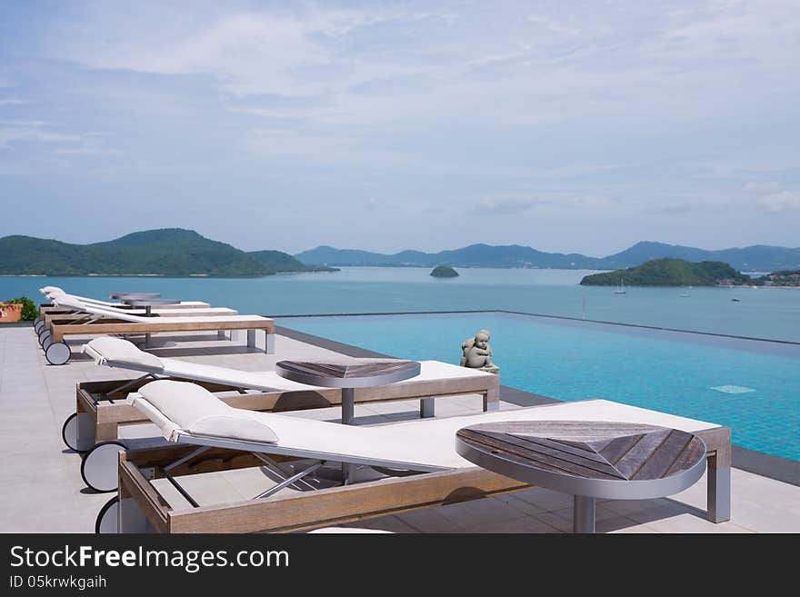 Tropical hotel sun bed and pool