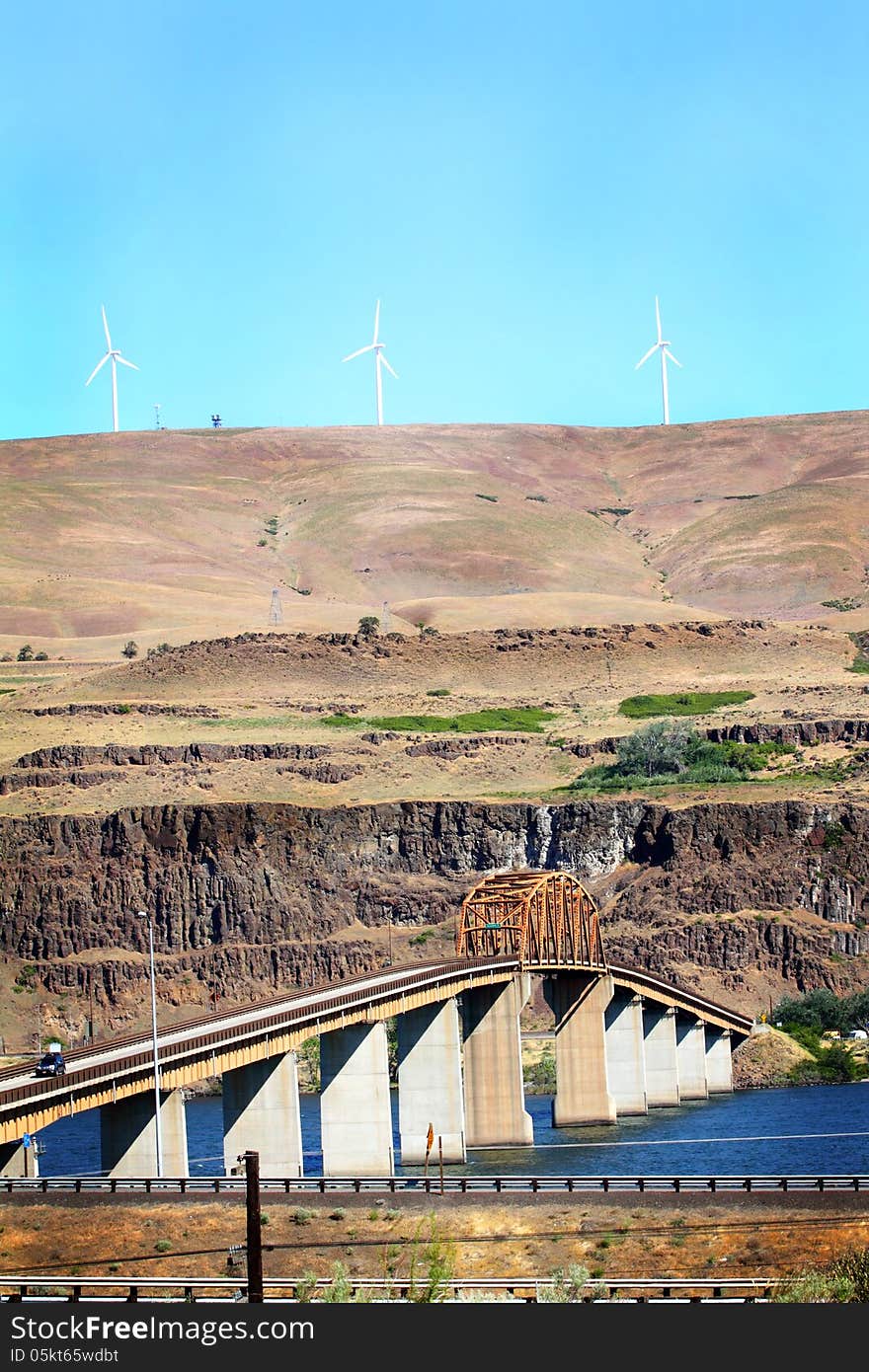 Looking north into Washington from Oregon is the Maryhill Bridge that crosses the Columbia River. Hills of Washington in the background. Tall to allow for barges and river traffic. Copy space. Looking north into Washington from Oregon is the Maryhill Bridge that crosses the Columbia River. Hills of Washington in the background. Tall to allow for barges and river traffic. Copy space