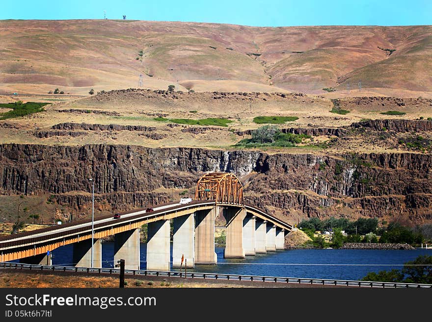 Looking north into Washington from Oregon is the Maryhill Bridge that crosses the Columbia River. Hills of Washington in the background. Tall to allow for barges and river traffic. Copy space