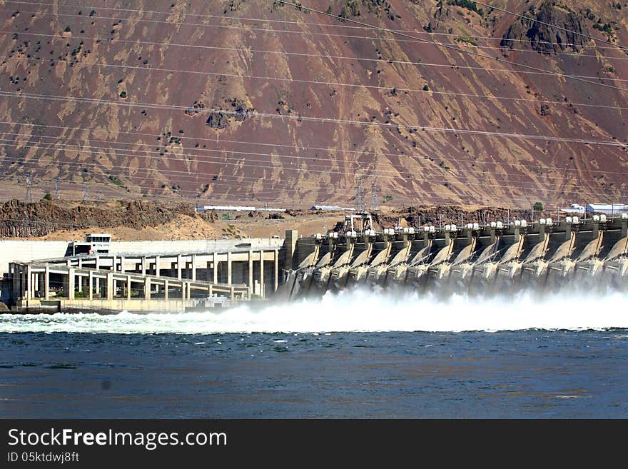 The John Day Dam view from visitor's parking lot, on the Columbia River with electical power lines overhead. The John Day Dam view from visitor's parking lot, on the Columbia River with electical power lines overhead.