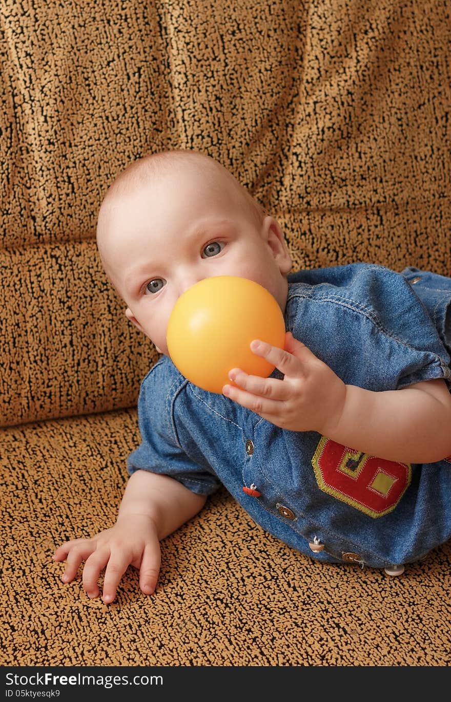 Portrait of the baby boy on yellow sofa. Portrait of the baby boy on yellow sofa.