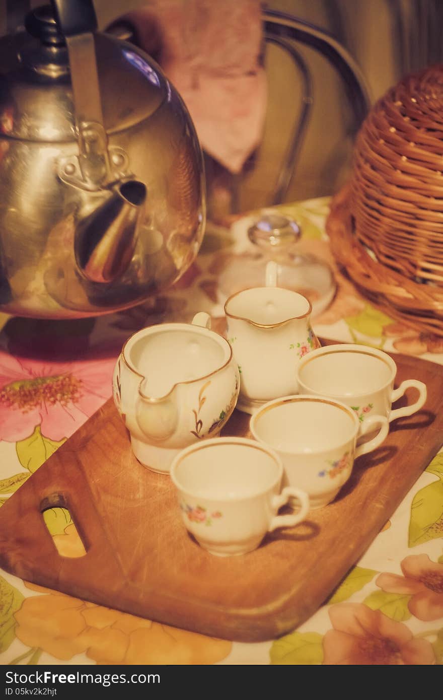 Horizontal photo, of the steel teapot tea flow in cup