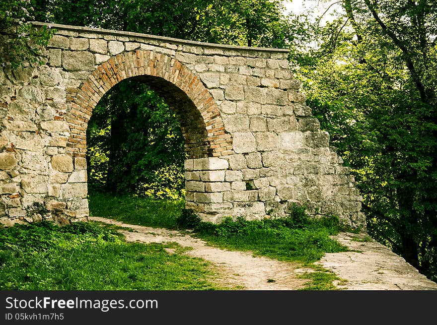 An ancient stone arch in the forest