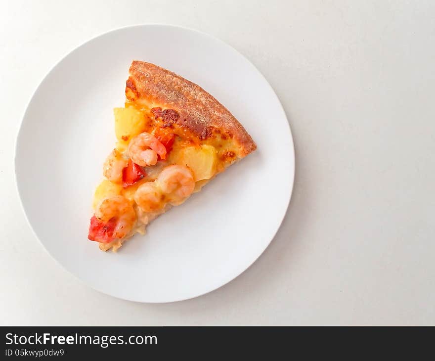 Cut off slice pizza on white dish