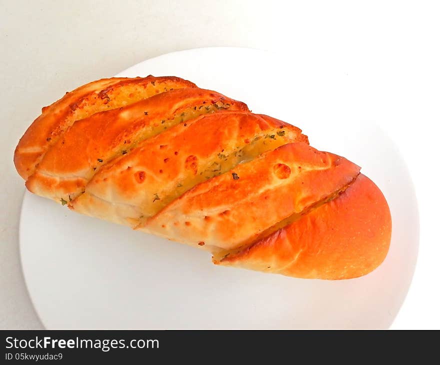 Close up of garlic bread on white dish