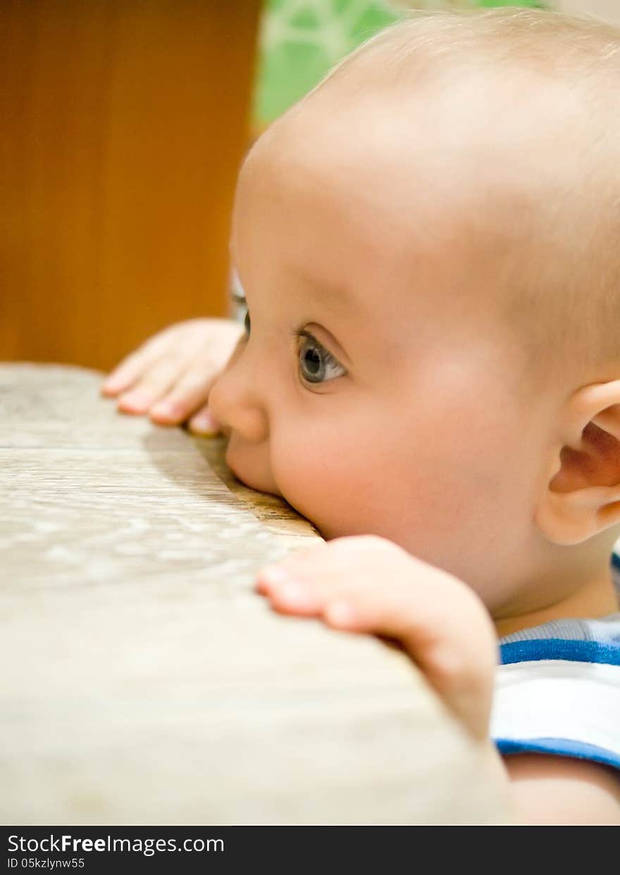 Kid in a chair chewing profile. Kid in a chair chewing profile