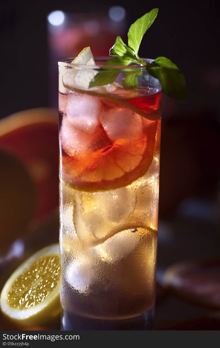 Fresh and cold ice tea with sliced grapefruit, lemon and mint