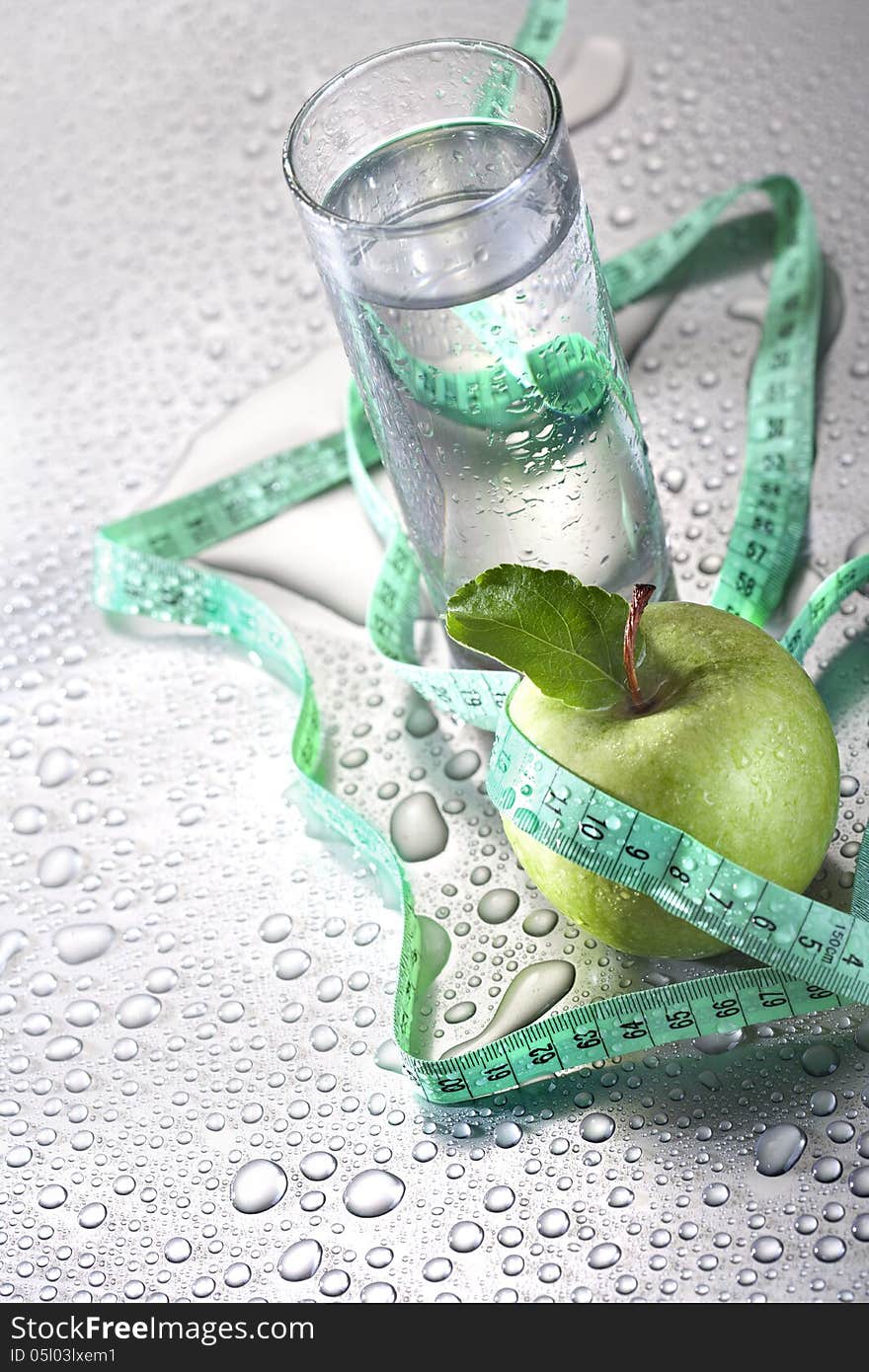 Healthy concept - apple glass of water and tape. Healthy concept - apple glass of water and tape